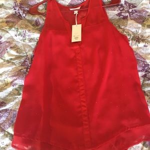 Candi’s red sleeveless blouse